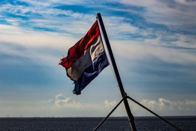 Low angle view of dutch flag against sky