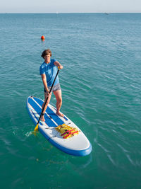 Paddle boarder. sportsman paddling on stand up paddleboard. sup surfing. active lifestyle. 