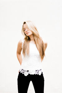 Portrait of woman standing against white background