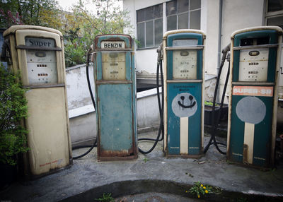 Abandoned fuel pumps outside building