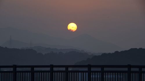 Scenic view of silhouette mountains against sky during sunrise