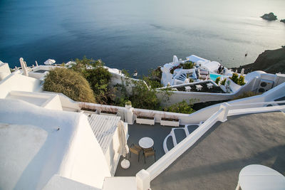 High angle view of houses on mountain by sea during sunset