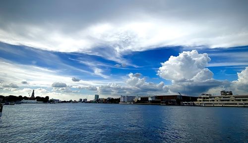 Panoramic view of sea and buildings against sky