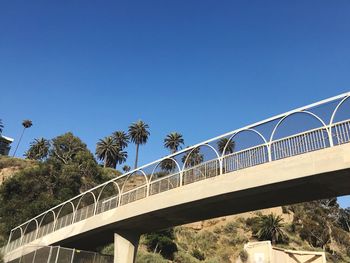 Low angle view of bridge against clear blue sky