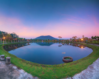 Scenic view of lake against sky at sunset