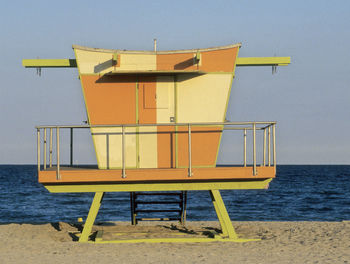 Lifeguard hut on beach against clear sky