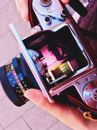 Close-up of person watching photographs in camera