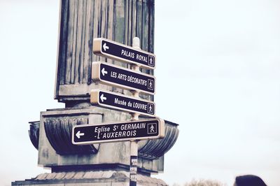Low angle view of signboard against clear sky