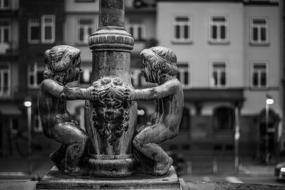 Close-up of statue against temple in city