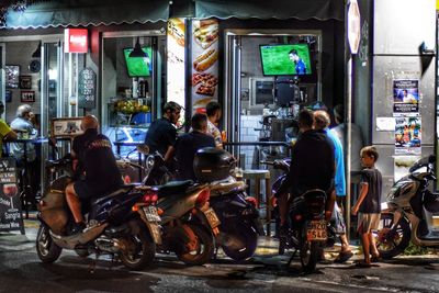 People riding motorcycle on street at night