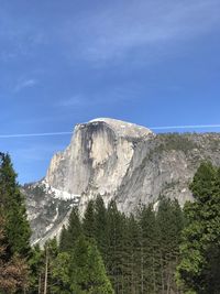 Scenic view of mountains against blue sky