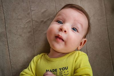 Close-up of baby lying on bed