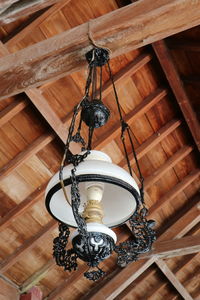 Low angle view of illuminated pendant lights hanging from ceiling