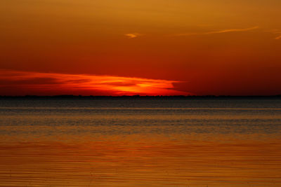 Scenic view of sea against romantic sky at sunset