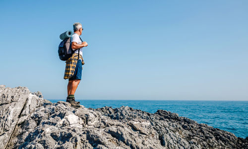 Senior man hiking looking at sea landscape