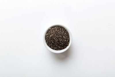 Close-up of roasted coffee beans against white background