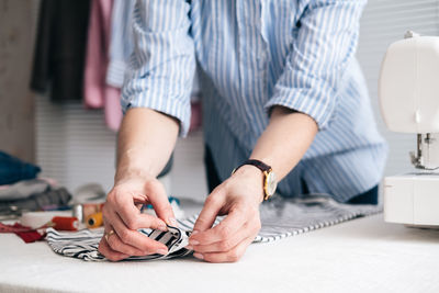 Midsection of craftswoman working on table