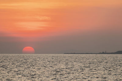 Scenic view of sea against orange sky