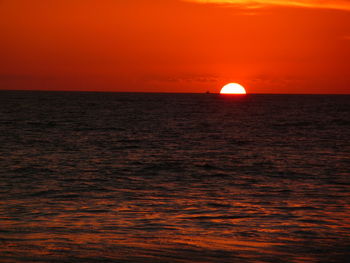 Scenic view of sea against orange sky