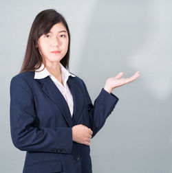 Portrait of a beautiful young woman over white background