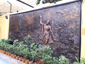 Statue of potted plants outside building