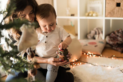 Mother and daughter playing with baby