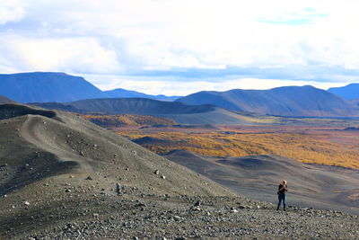 Man standing on mountain against sky