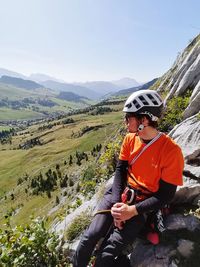 Young man sitting on mountain