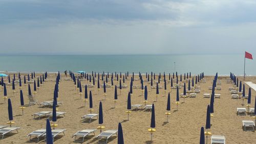 Umbrellas on beach against sky