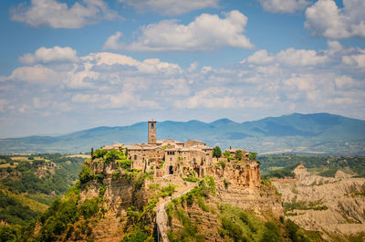 Castle on mountain against blue sky