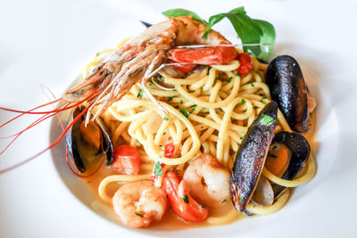 Close-up of pasta with clams and shrimp served in plate