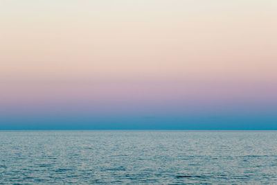 Scenic view of sea against clear sky during sunset