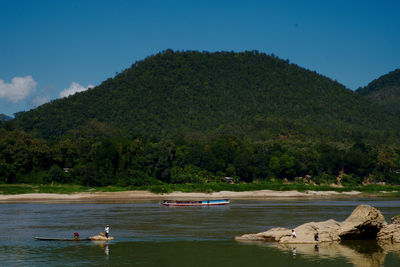 Scenic view of lake against tree mountain