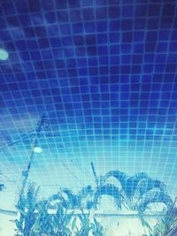 Close-up of illuminated swimming pool against blue sky
