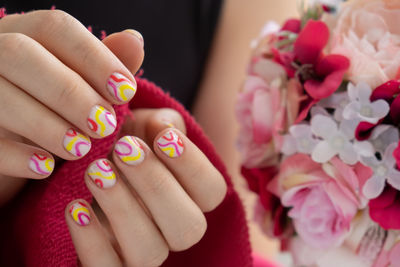 Midsection of bride holding bouquet