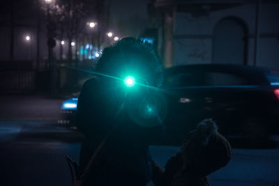 View of illuminated street in city at night