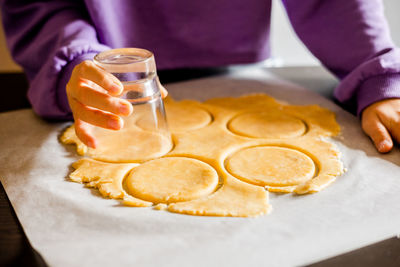 Midsection of woman holding food on table