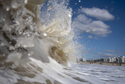 Sea waves splashing against blue sky