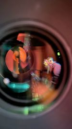 Reflection of woman photographing in mirror