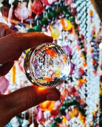 Close-up of hand holding crystal ball