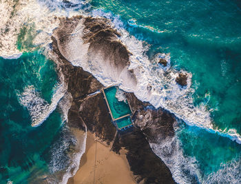 High angle view of rock formation in sea