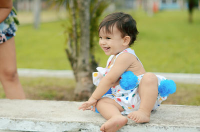 Cute girl sitting outdoors