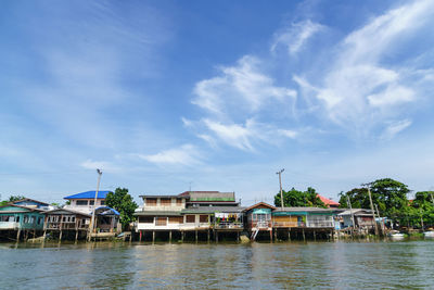 Boats in river with buildings in background