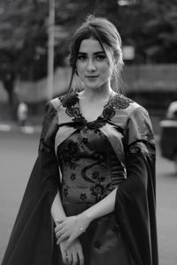 Portrait of woman standing outdoors