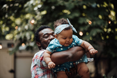 Father and son with daughter outdoors