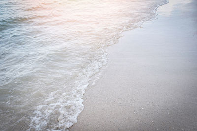 High angle view of waves rushing towards shore