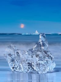 Frozen sea against sky during winter