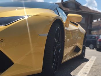 Close-up of yellow car on the road