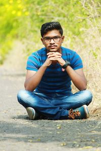 Portrait of young man sitting outdoors