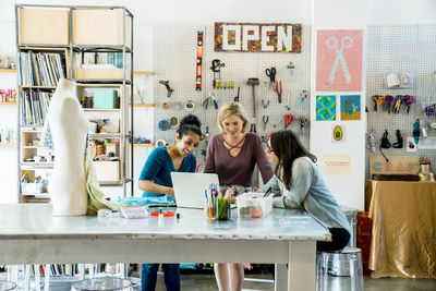 Businesswomen working on laptop computer in creative office
